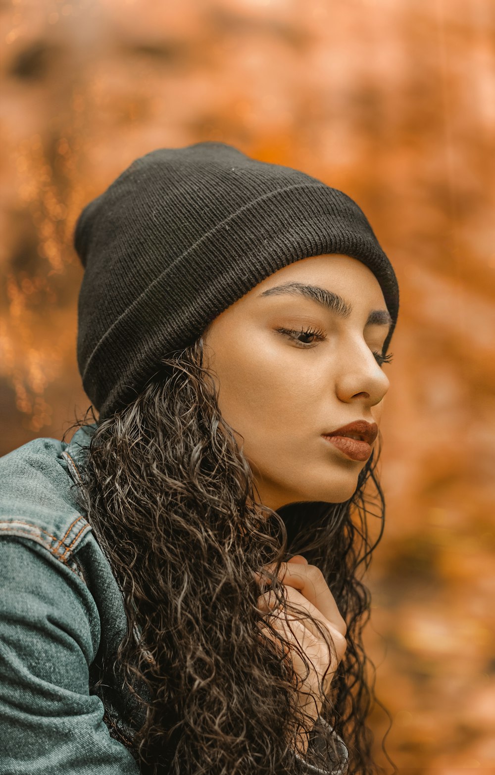 woman in blue denim jacket and black knit cap