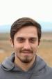 man in gray hoodie smiling