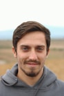 man in gray hoodie smiling