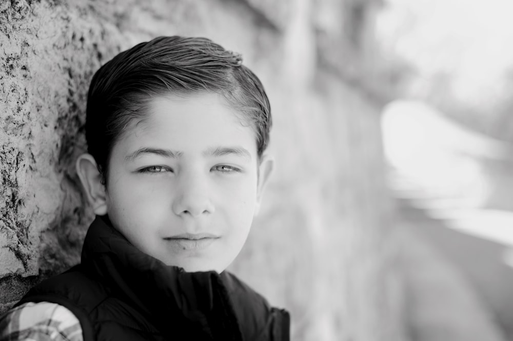 grayscale photo of boy in black jacket