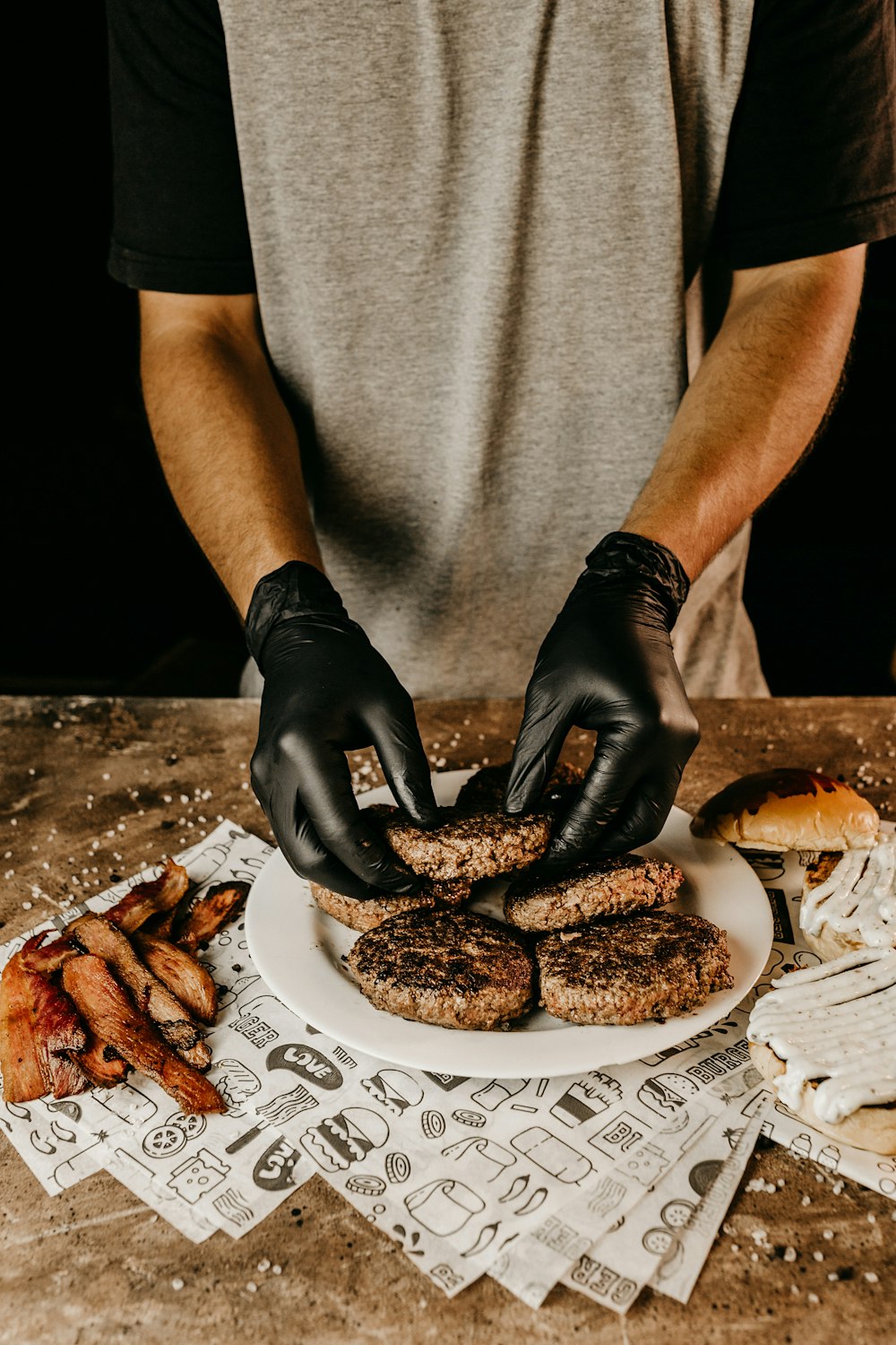 man in gray t-shirt holding black pastry