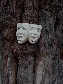 white face mask on brown tree