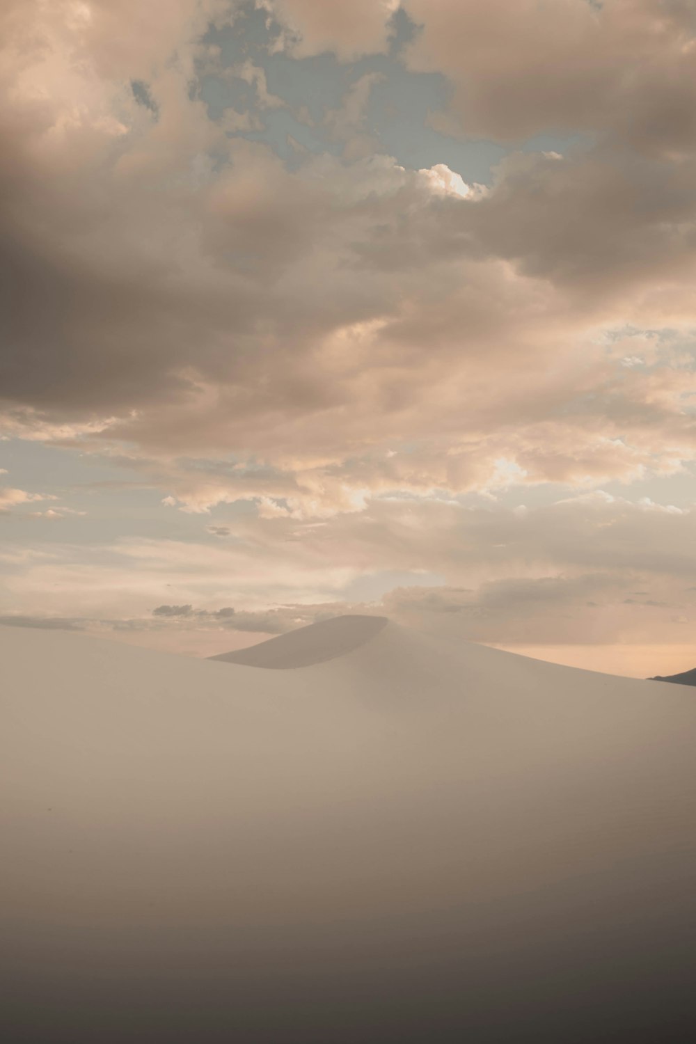 white clouds over mountains during daytime