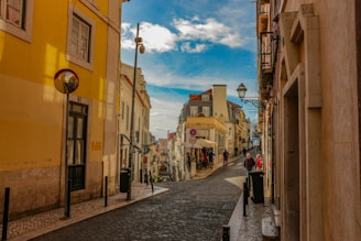 people walking on street between buildings during daytime