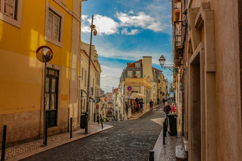 people walking on street between buildings during daytime