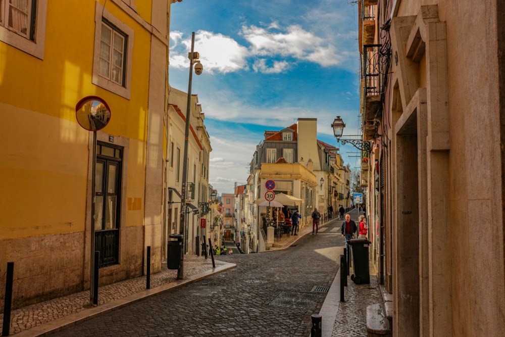 people walking on street between buildings during daytime