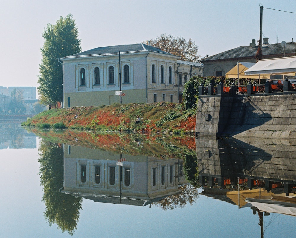 white and gray concrete building beside body of water during daytime