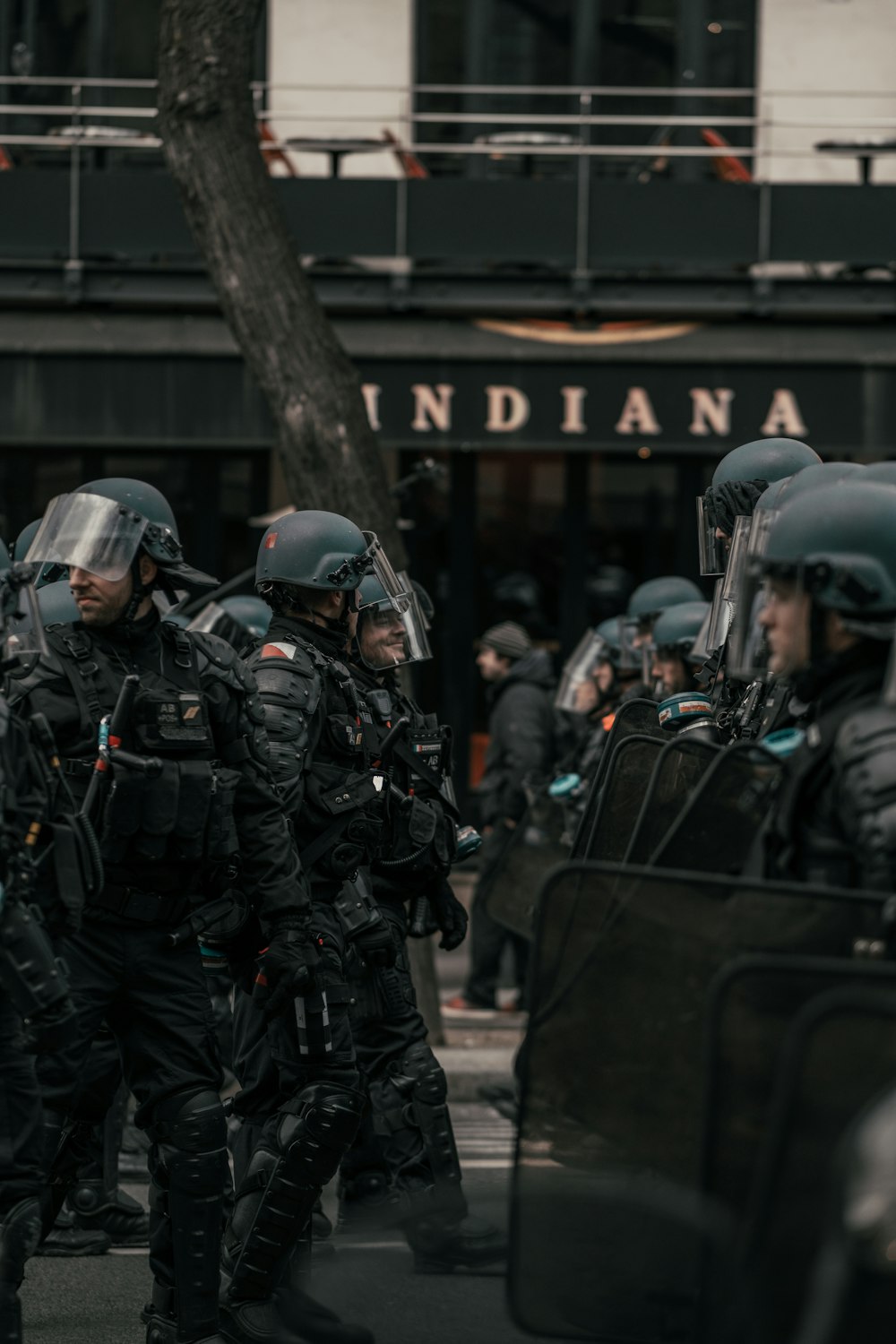 group of men in black and gray helmet and helmet standing near black car during daytime