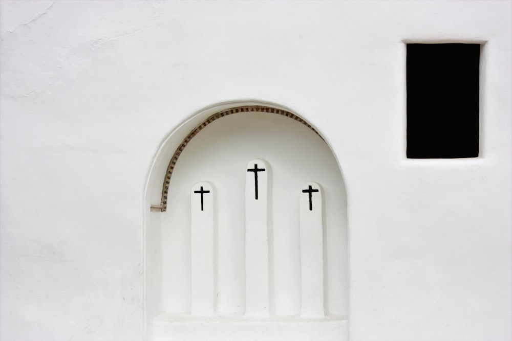 white concrete wall with black wooden door