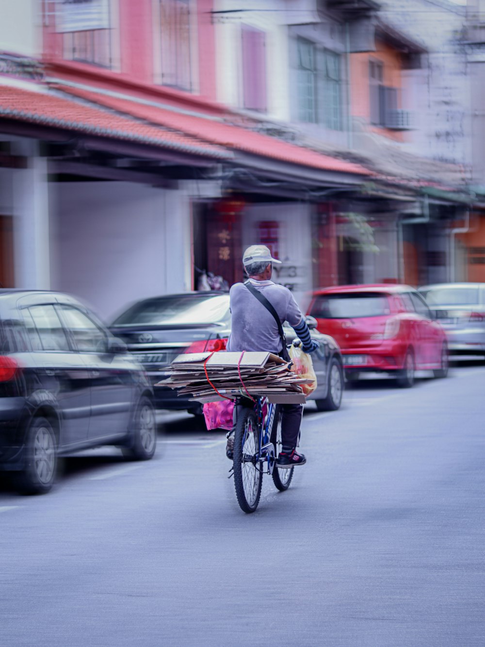 man in black jacket riding bicycle on road during daytime