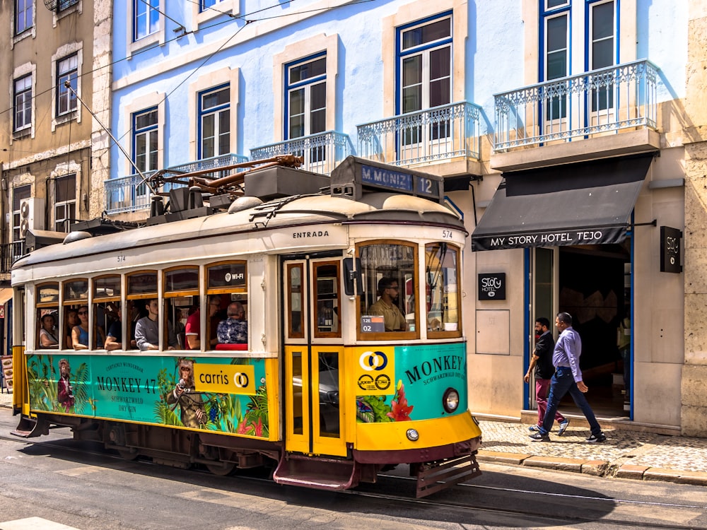 yellow and white tram on road during daytime