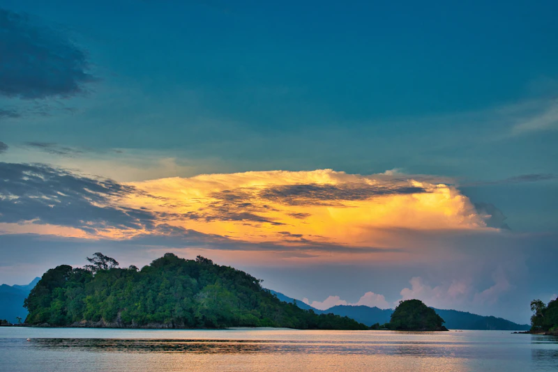 Forested Langkawi islands at golden hour during an island-hopping excursion