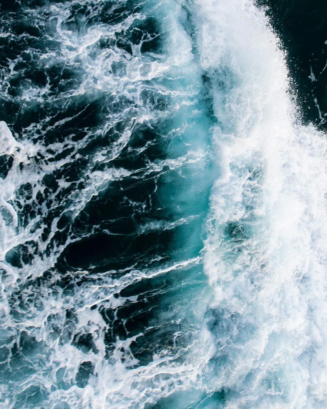 water waves hitting rocks during daytime