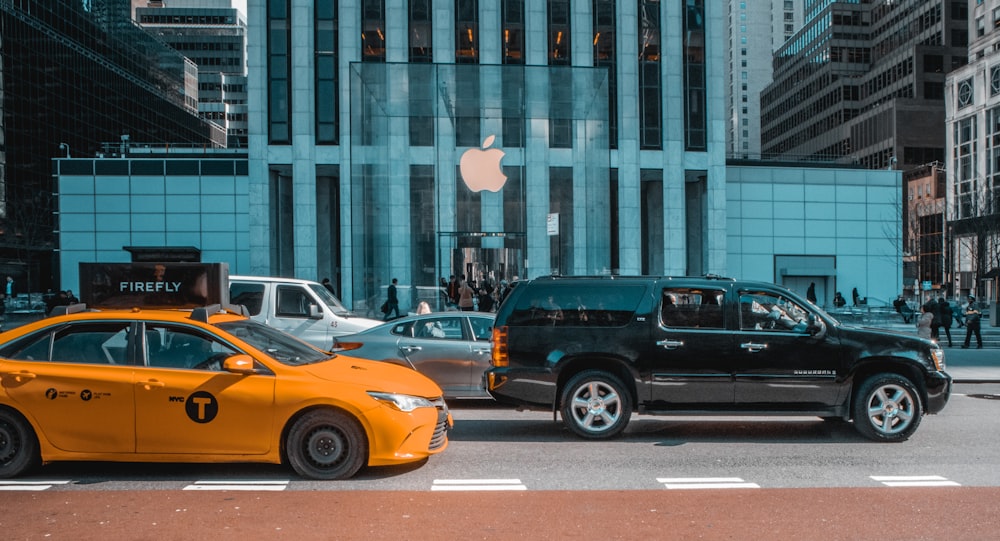 black and yellow cars on road near building during daytime