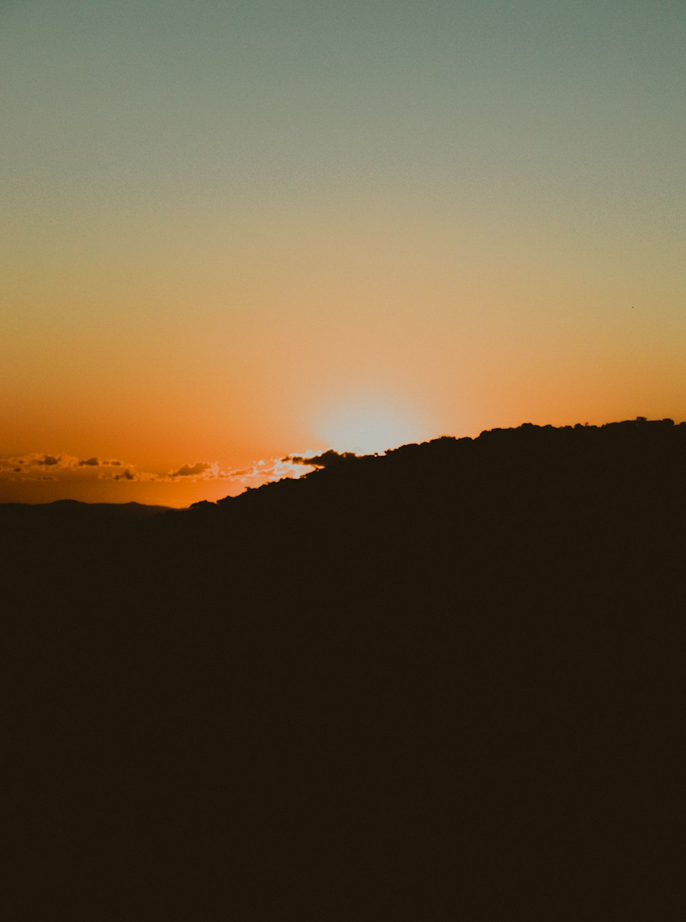 silhouette of mountain during sunset