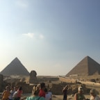 A traveler enjoying a guided tour at an ancient Egyptian landmark.