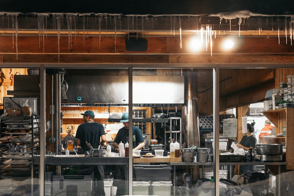 man in black t-shirt standing in front of counter