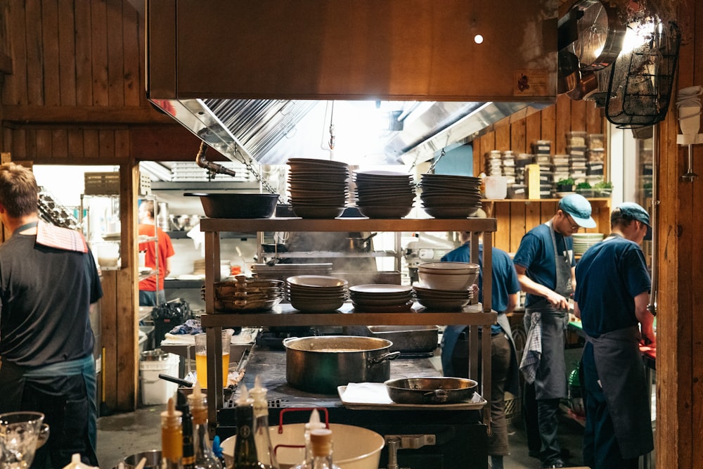 man in blue polo shirt standing near black cooking pot