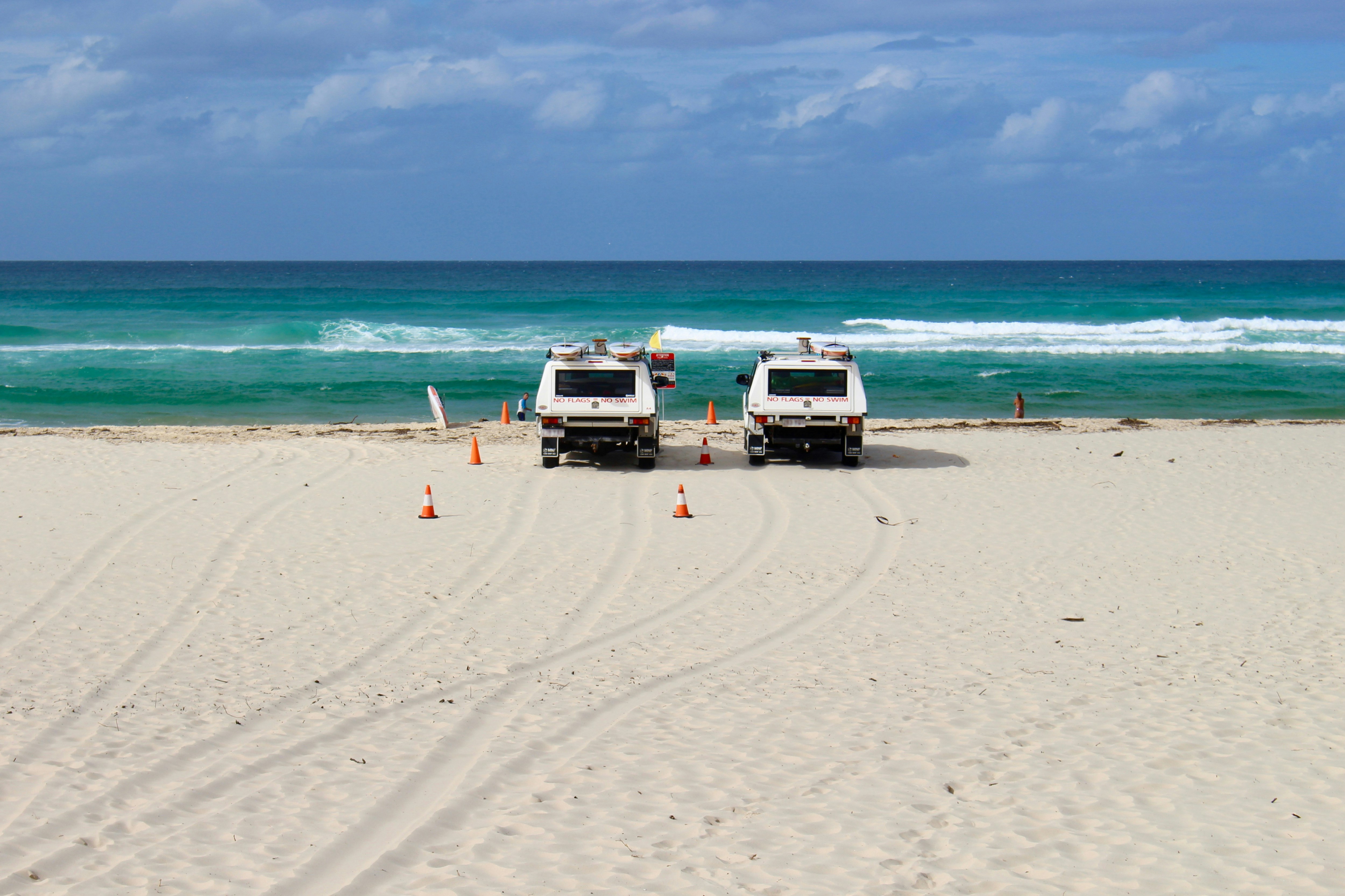 Life guard trucks at beach.