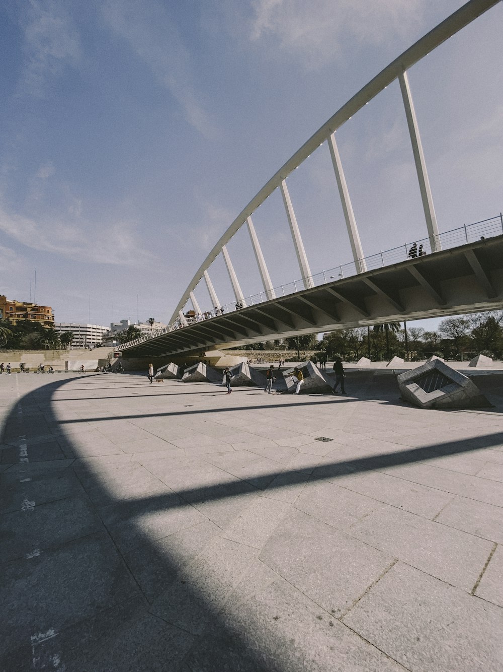 people walking on gray concrete road under blue sky during daytime