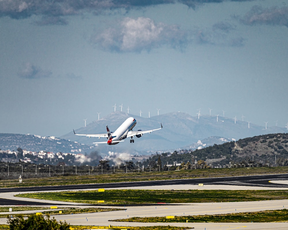 white and red airplane on airport during daytime