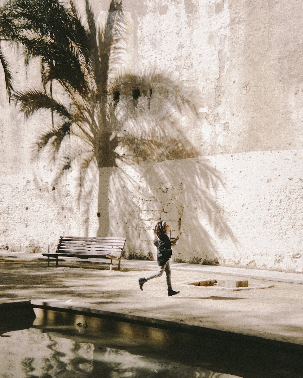 person walking on snow covered ground near trees