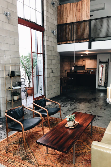 A sturdy industrial coffee table with a reclaimed wood top and black metal frame in a cozy living room setting.