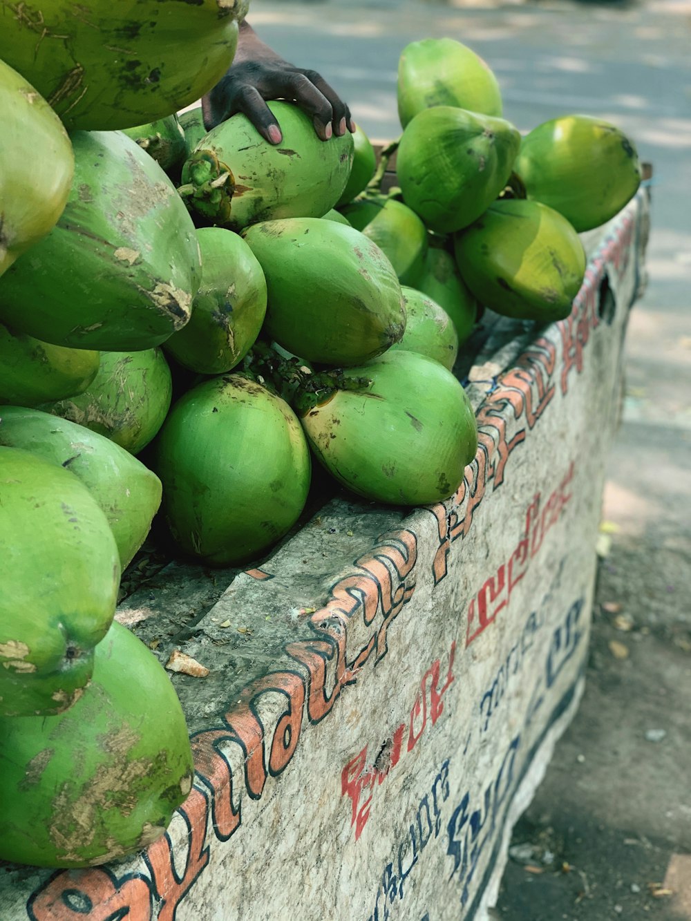 green coconut fruits on gray concrete floor