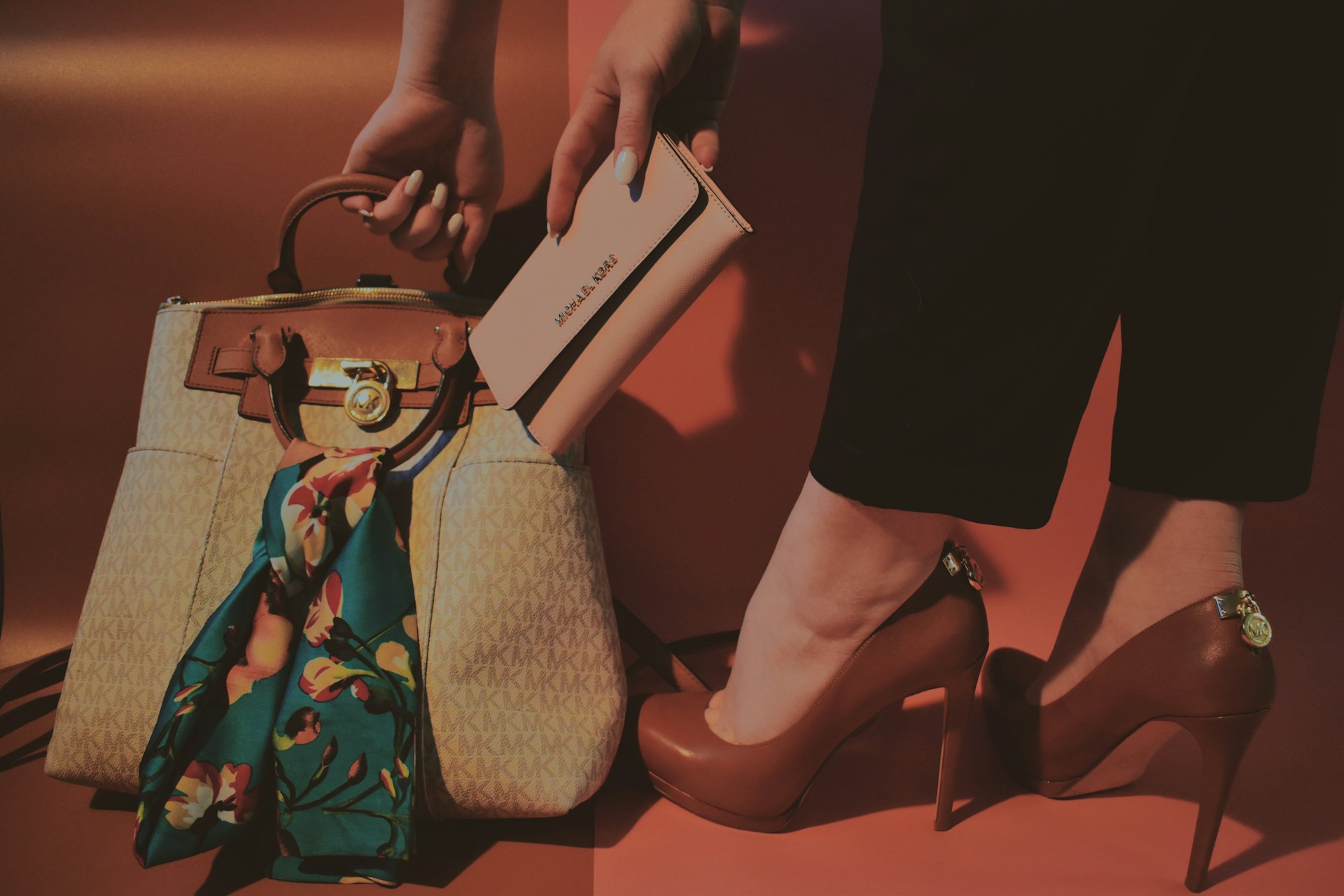 woman in black dress holding white leather handbag