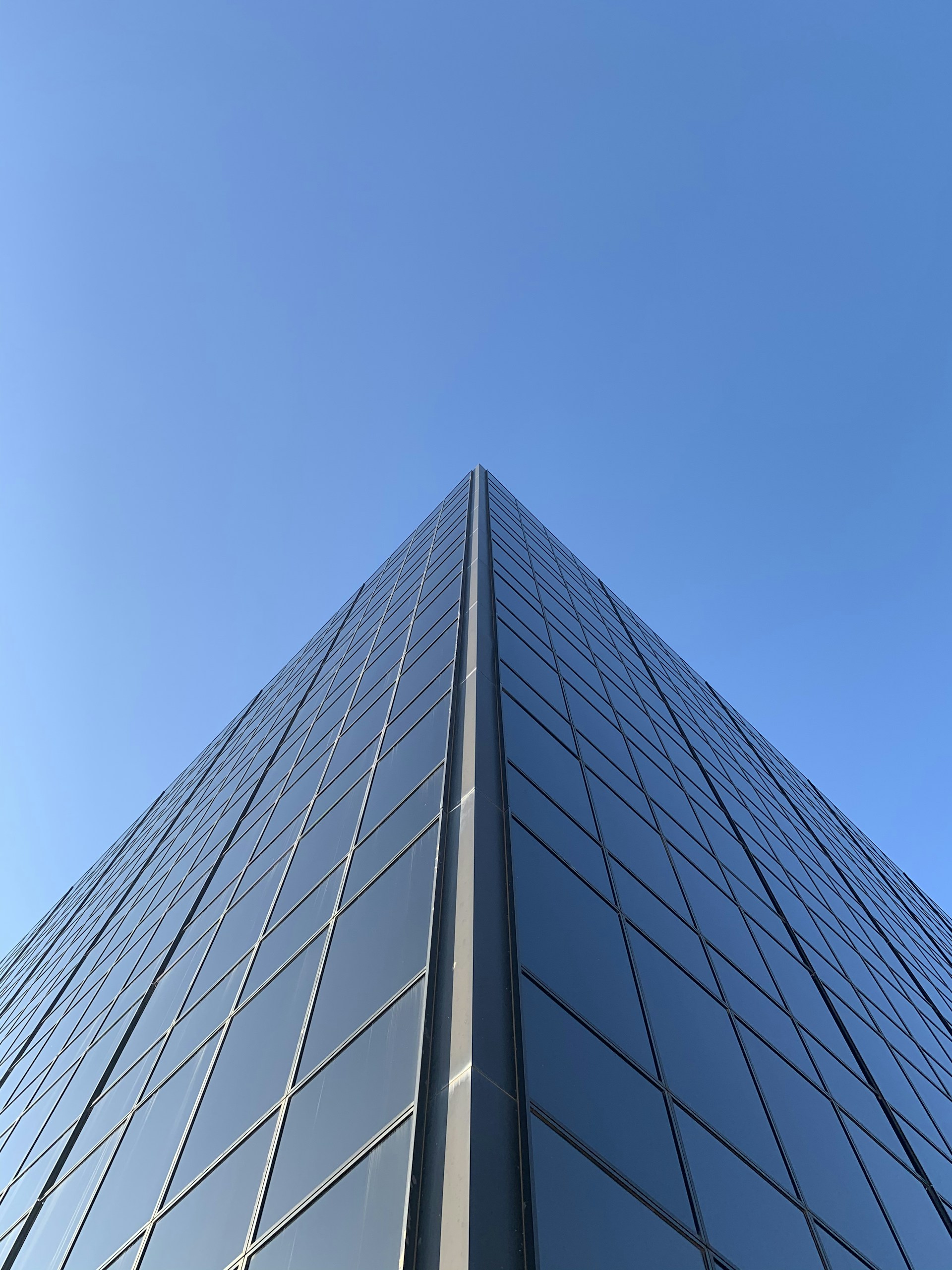 blue glass walled high rise building