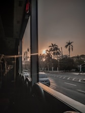 A comfortable modern bus cruising along a scenic Brazilian highway at sunset.