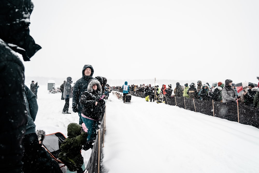 people on snow covered field during daytime