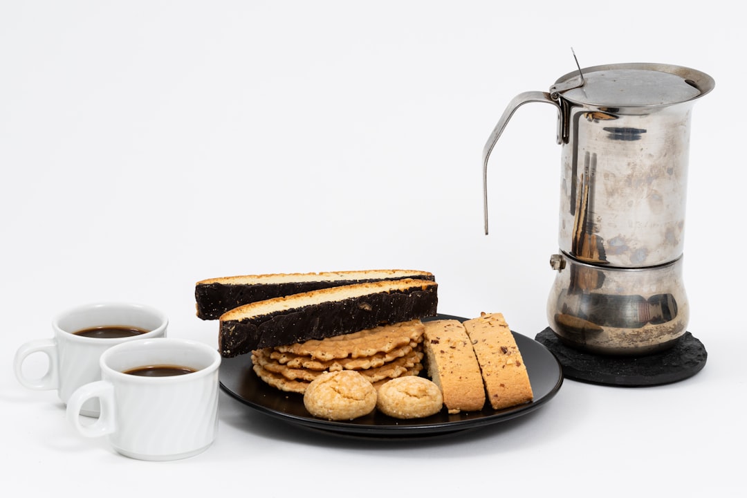 bread on brown wooden tray beside white ceramic mug