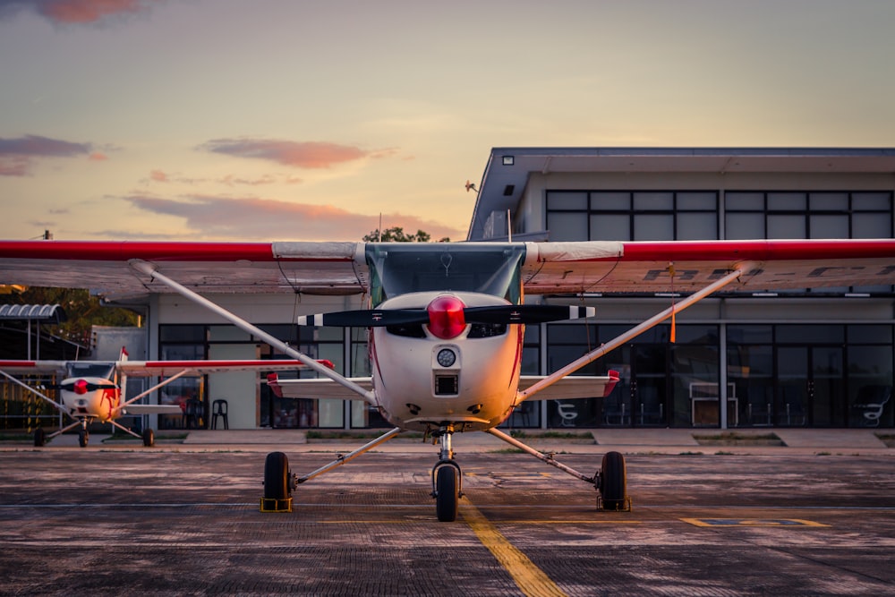 white and red airplane on airport during daytime