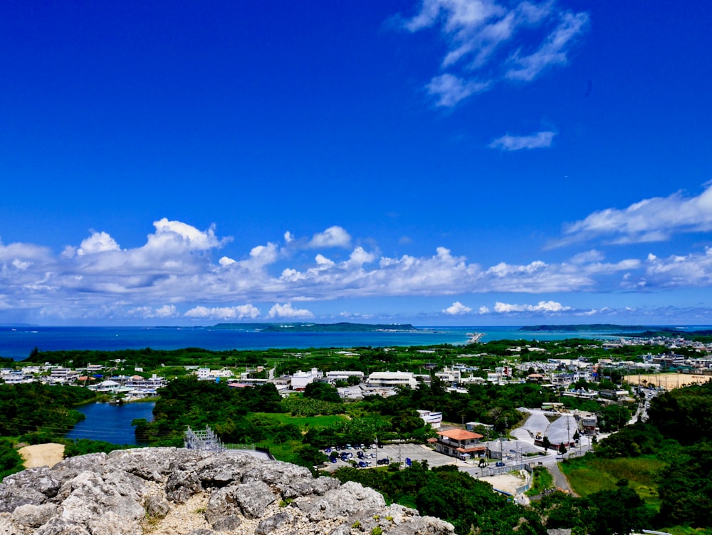 white and blue sky over city and sea during daytime