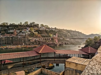 brown and white houses near body of water during daytime