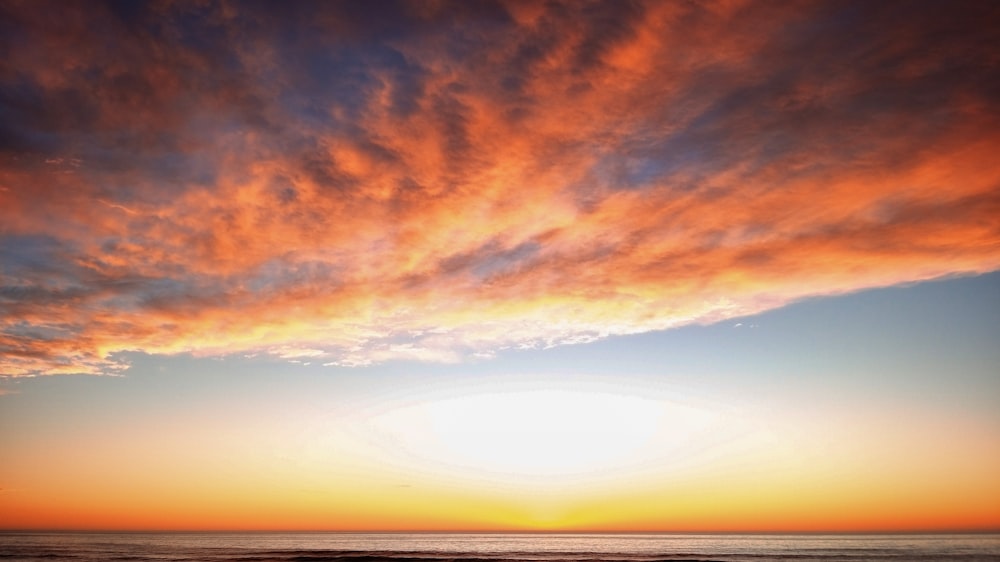 orange and blue cloudy sky during sunset