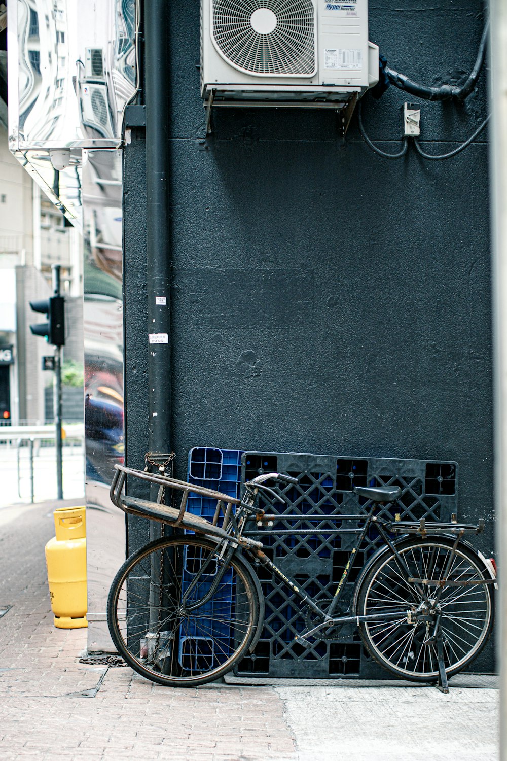 blue city bike beside black wall