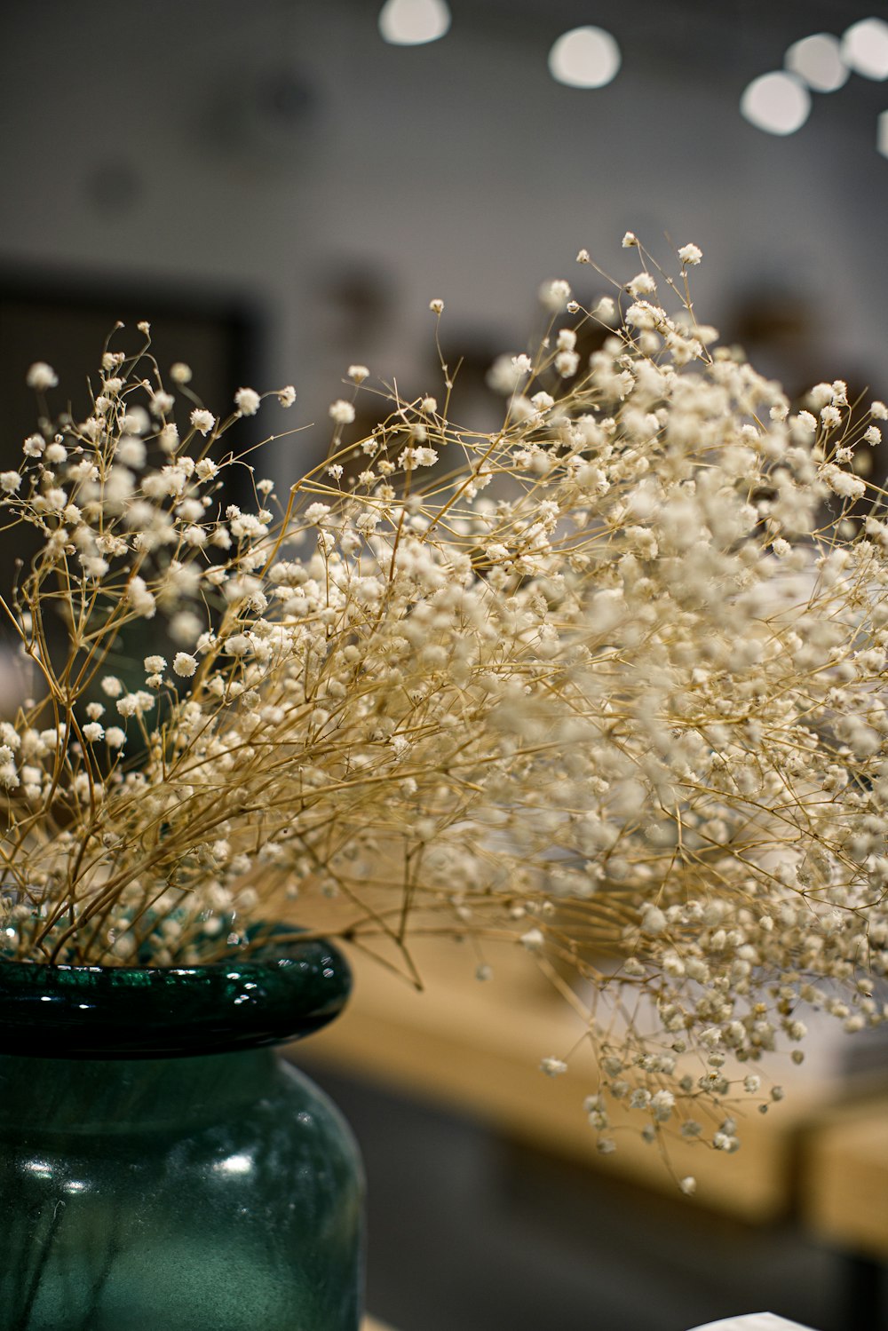 white flowers on green ceramic vase