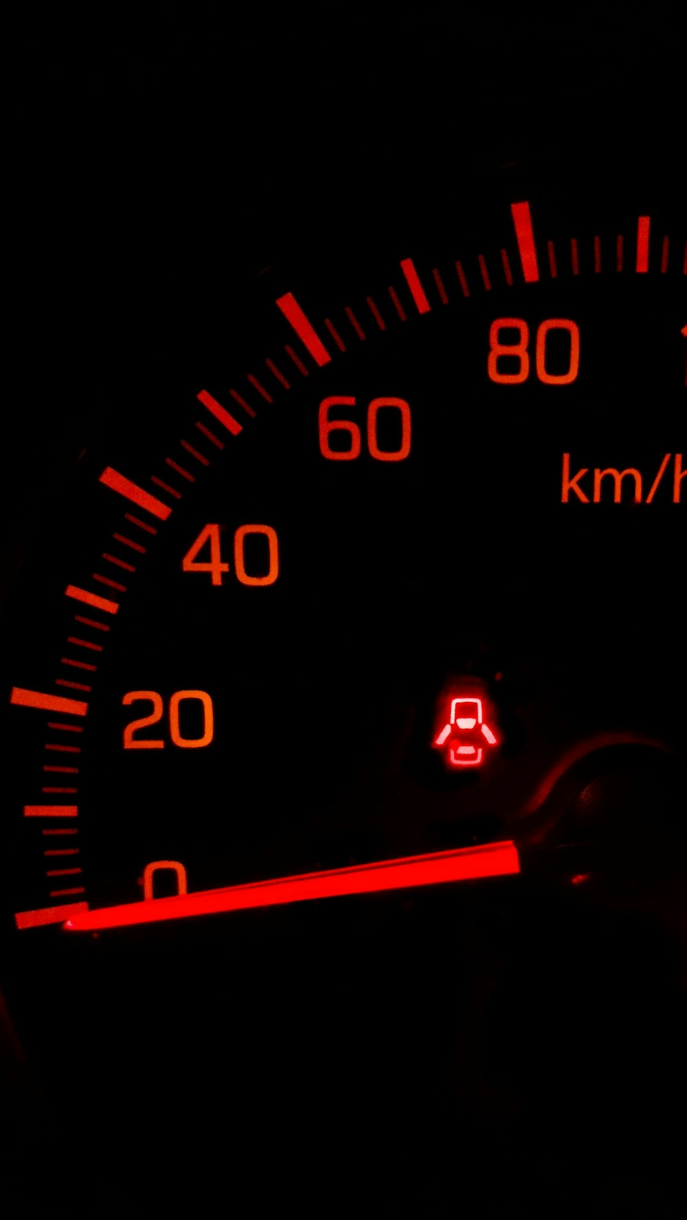 black and red speedometer at 0