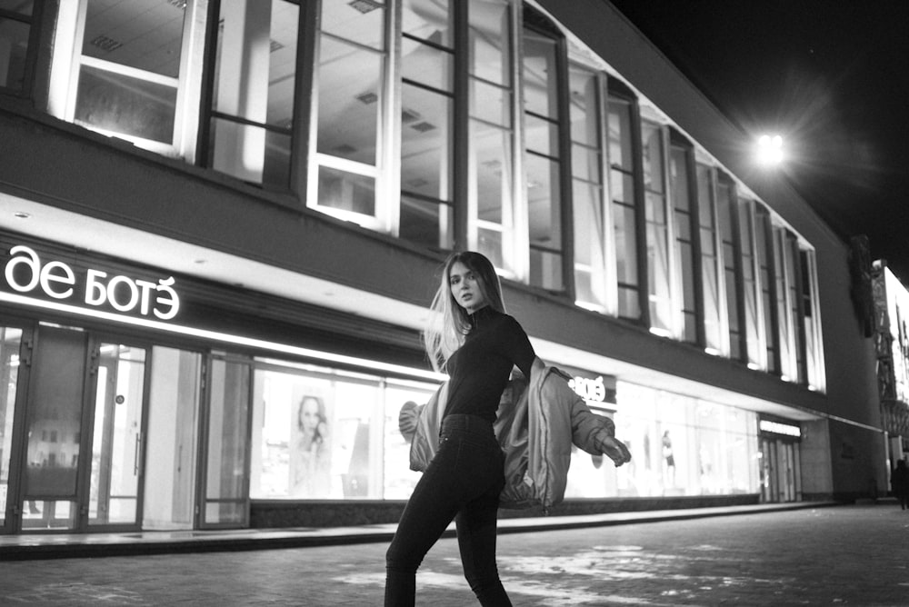 woman in black jacket and pants standing on floor