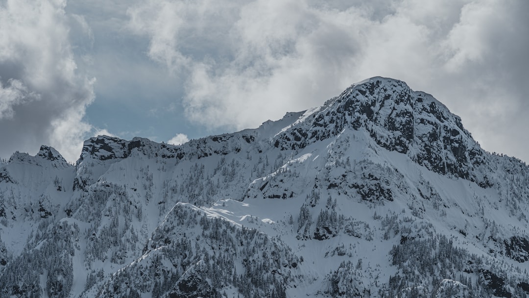 snow covered mountain under cloudy sky during daytime