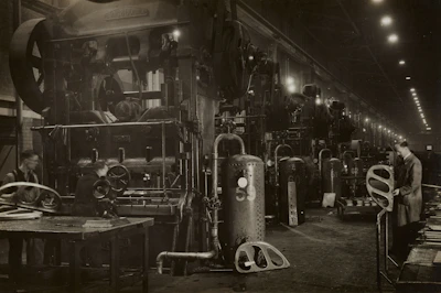 Interior shot of a factory floor with machinery and workers.