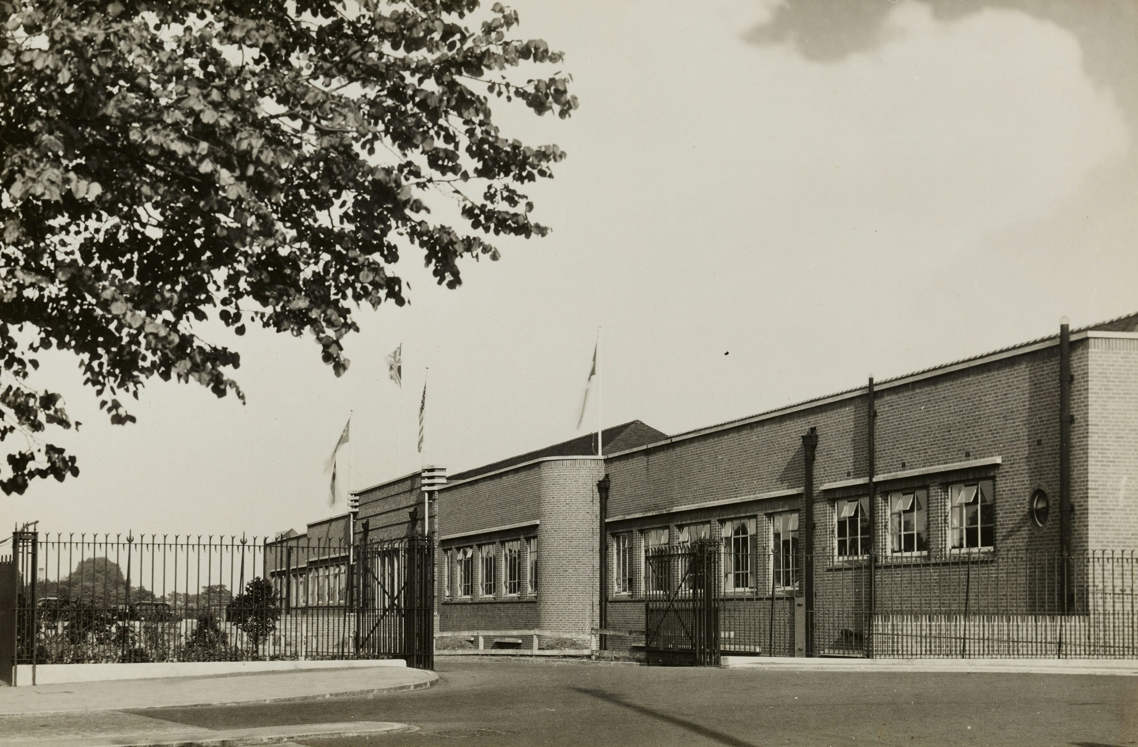 grayscale photo of building near trees