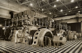 Technicians performing advanced repairs on a ship’s engine in a high-tech facility.