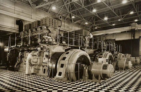 Industrial factory floor with large mechanical equipment in operation.
