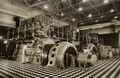 Skilled engineers inspecting advanced electromechanical systems in a high-tech industrial facility.