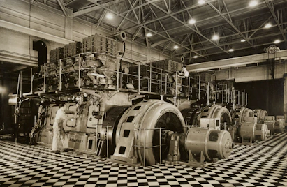 Team members working on mechanical systems inside a retail outlet under construction.