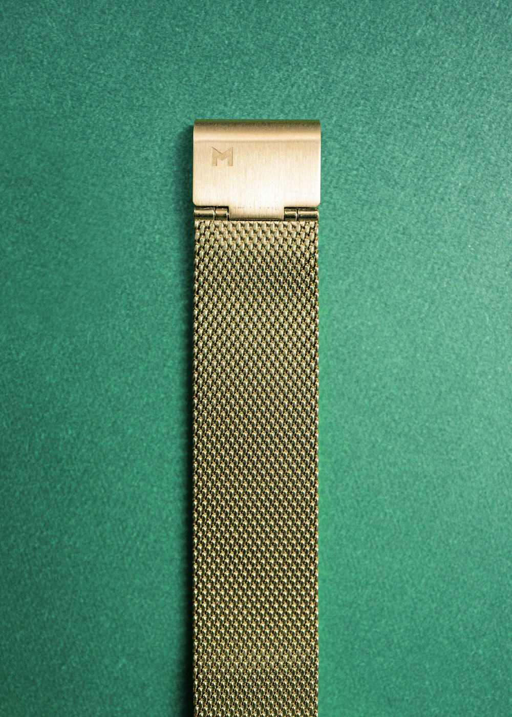 silver and white band on green textile