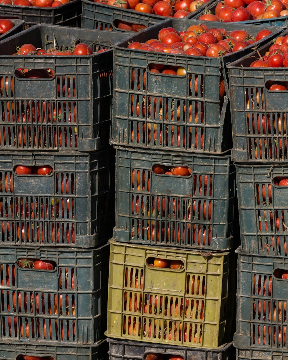 a pile of crates filled with lots of red apples